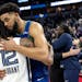 Ja Morant (12) of the Memphis Grizzlies and Karl Anthony-Towns (32) of the Minnesota Timberwolves greet each other at the end of game 6.