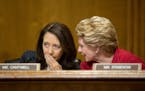 Sens. Maria Cantwell (D-Wash.), left, and Debbie Stabenow (D-Mich.) confer during a Senate Finance Committee hearing to examine the Children's Health 