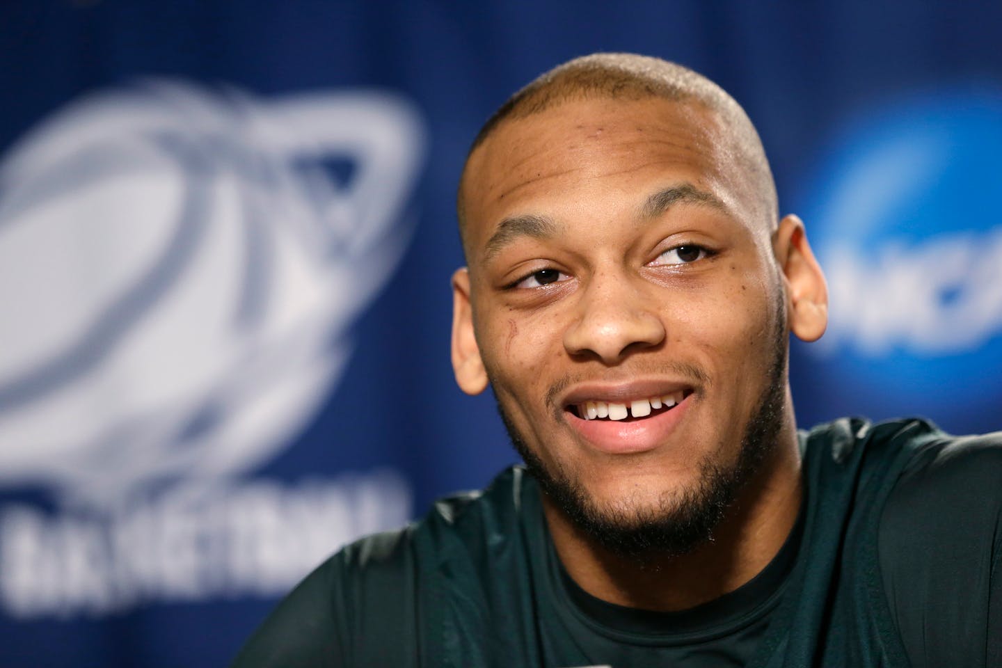 Michigan State's Adreian Payne smiles while answering a question at a news conference before the third round of the NCAA men's college basketball tournament in Spokane, Wash., Friday, March 21, 2014. Michigan State plays Harvard on Saturday. (AP Photo/Elaine Thompson) ORG XMIT: WAET107