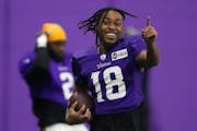 Minnesota Vikings wide receiver Justin Jefferson (18) works on his one-handed catches during practice.