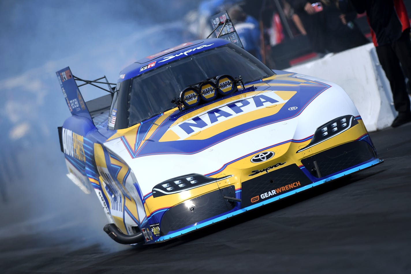 In this photo provided by the NHRA, reigning Funny Car champion Ron Capps earns his 75th career NHRA win at the Lucas Oil NHRA Nationals auto race at Brainerd International Raceway in Brainerd, Minn., on Sunday, Aug. 20, 2023. (Marc Gewertz/NHRA via AP)