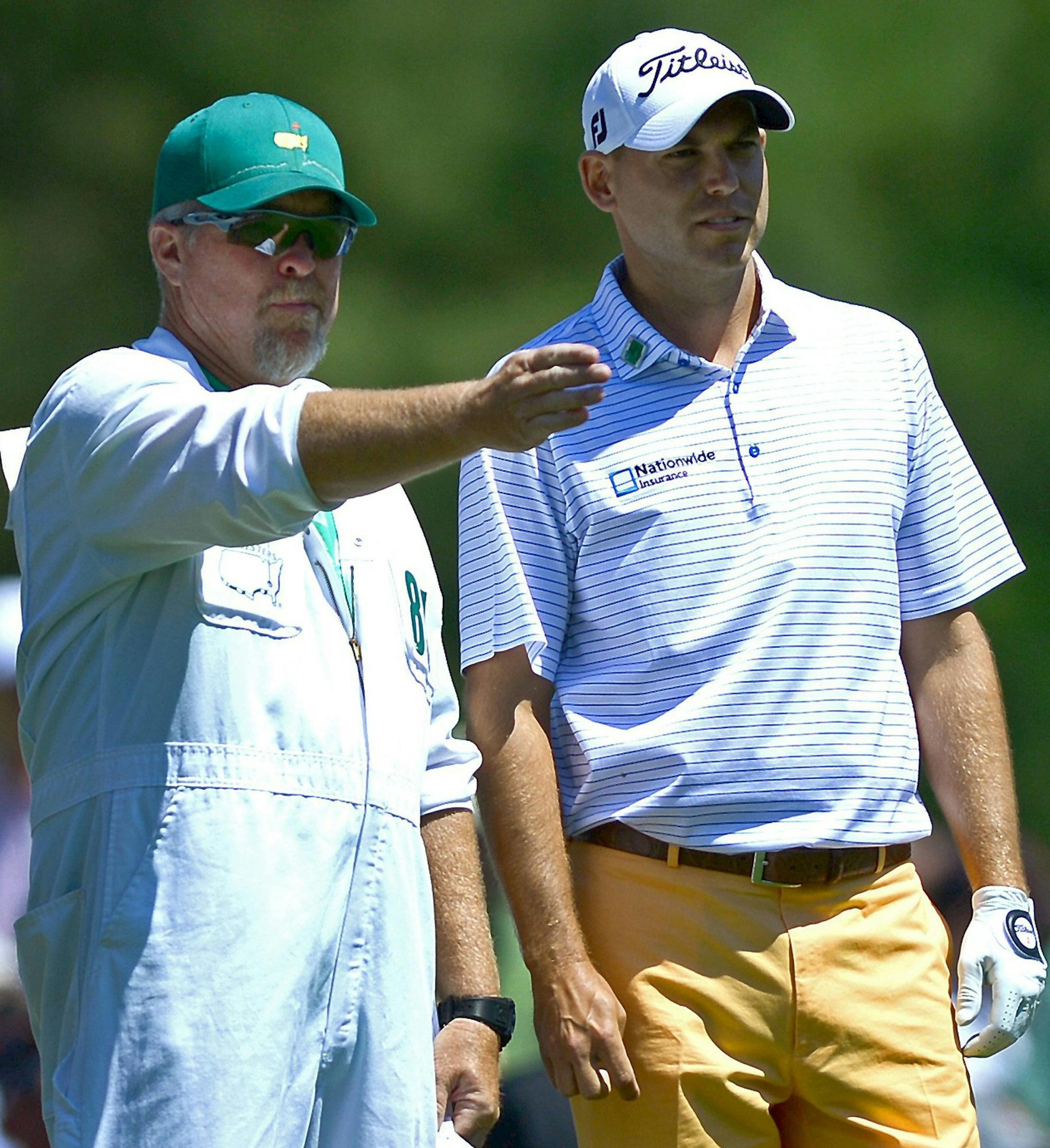 Bill Haas, right, listens to his caddie prior to hitting from the 12th tee during the first round of the Masters Tournament, Thursday, April 10, 2014, in Augusta, Ga. (Jeff Siner/Charlotte Observer/MCT)
