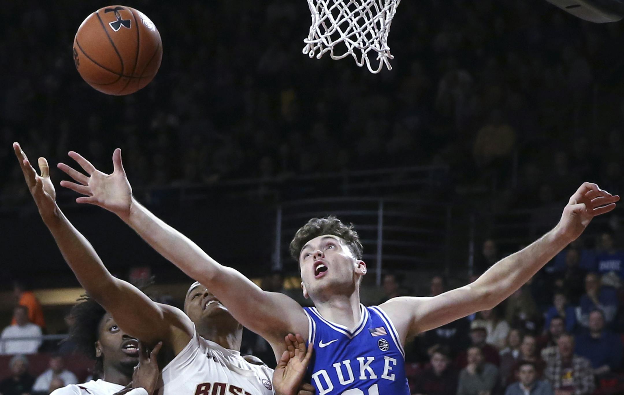 Duke forward Matthew Hurt (21) and Boston College forward Steffon Mitchell (41) battle for a loose ball during the first half of an NCAA college basketball game in Boston, Tuesday, Feb. 4, 2020. (AP Photo/Charles Krupa)