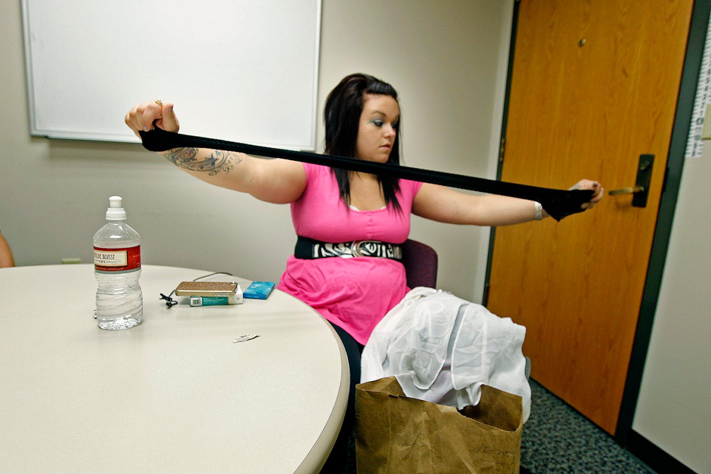 Bobbi Larson, a victim of sex trafficking, examines items in an evidence bag at the Minneapolis Police Department. It was filled with clothes, mostly negligees, that she had worn while she was trafficked.