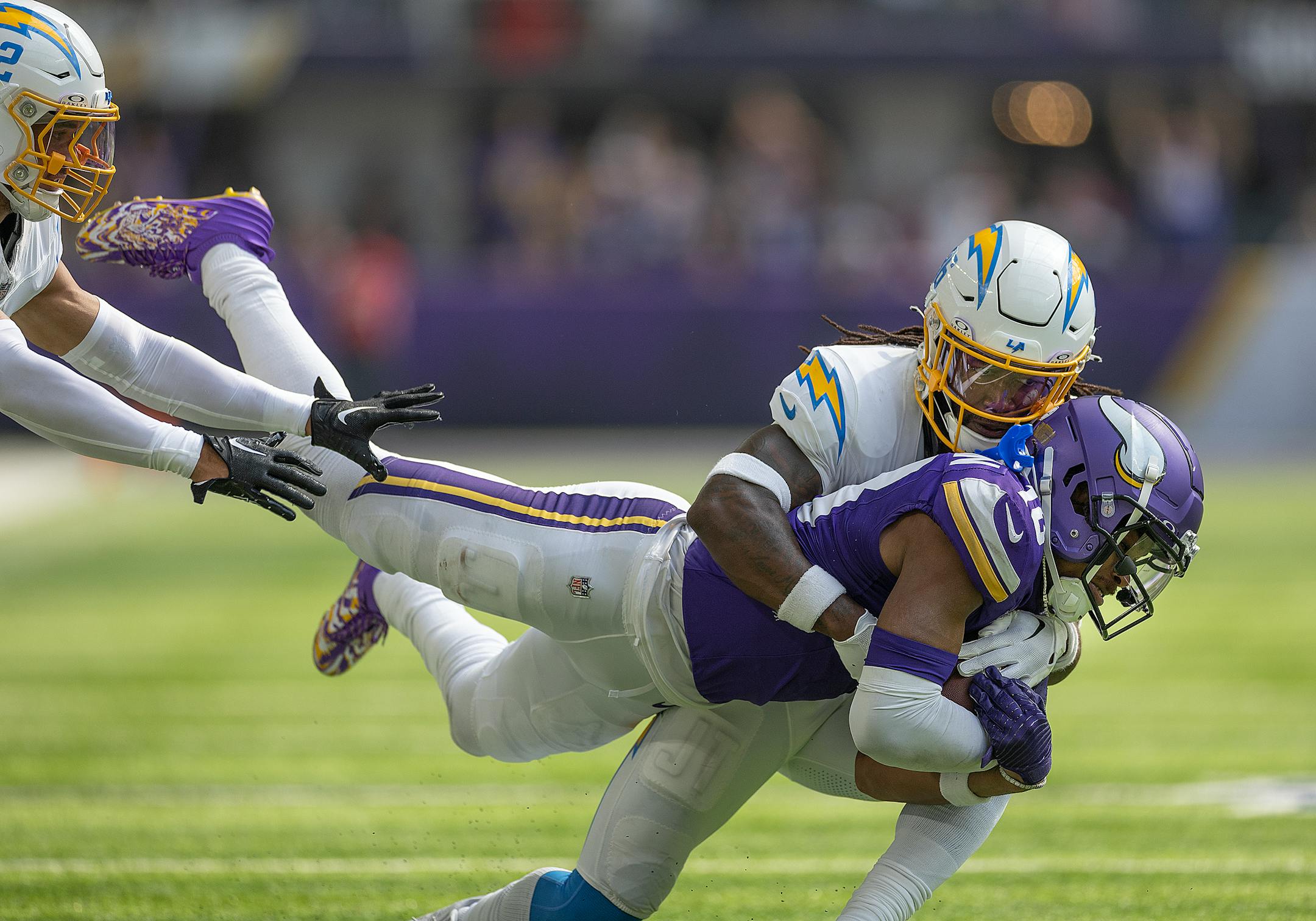 Los Angeles Chargers cornerback Ja'Sir Taylor (36) tackles Minnesota Vikings wide receiver Justin Jefferson (18) to bring him down during the second quarter of the game Sunday, September 24, 2023 in Minneapolis, Minn. The Minnesota Vikings hosted the Los Angeles Chargers at U.S. Bank Stadium. ] Elizabeth Flores • liz.flores@startribune.com