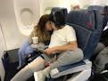 After getting overwhelmed and wanting to get off the plane, Andy Diaz, 13, found a comfortable seat in the first row with his mother, Linda Diaz.