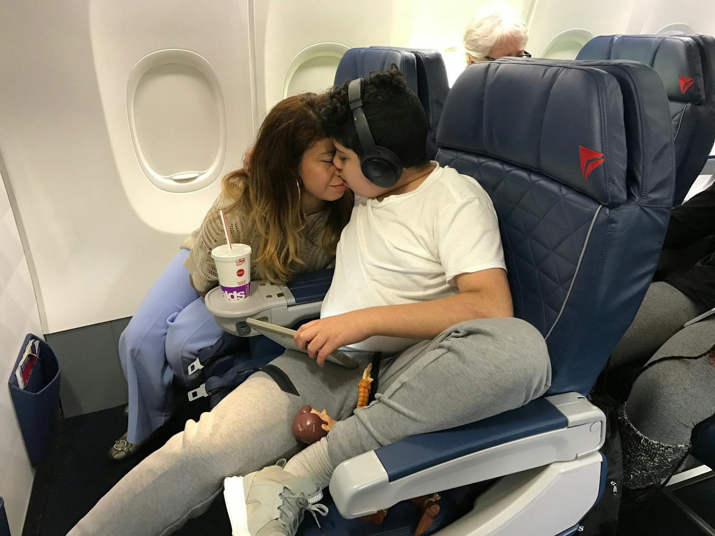 After getting overwhelmed and wanting to get off the plane, Andy Diaz, 13, found a comfortable seat in the first row with his mother, Linda Diaz.