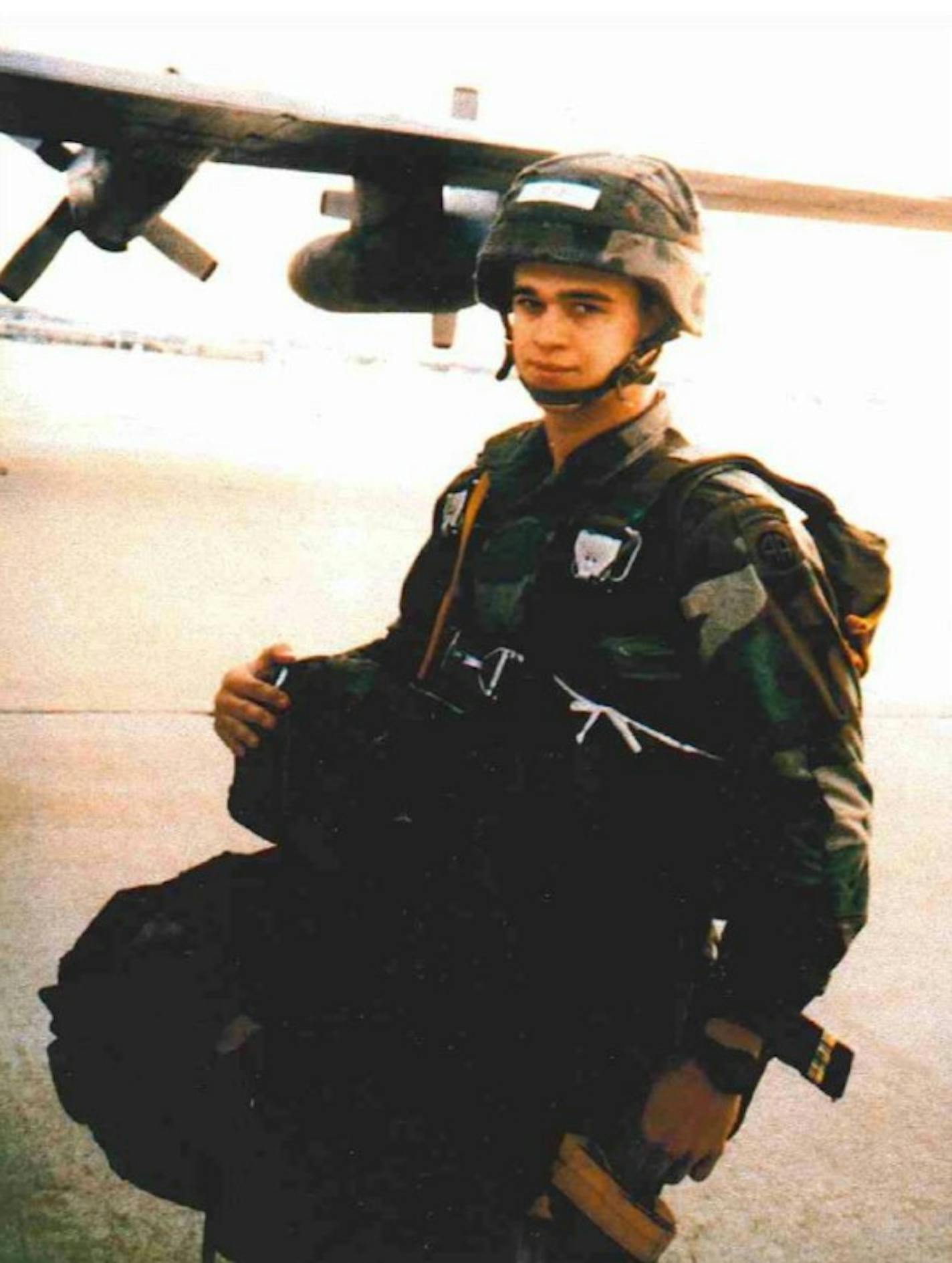 Darrell Robinson, shown wearing military gear in front of an airplane, when he served in the U.S. Army Airborne. He was honorably discharged in 1988.