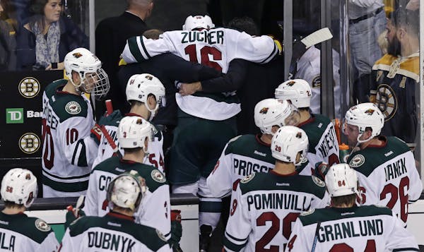 Minnesota Wild left wing Jason Zucker (16) is helped from the ice after an injury in the final seconds of the third period of an NHL hockey game again