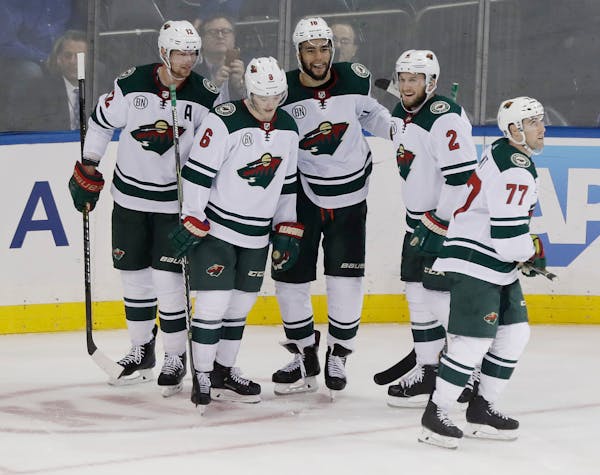 The Wild's Jordan Greenway, center, celebrates his empty-net goal with teammates Eric Staal, left, Ryan Donato, Anthony Bitetto and Brad Hunt