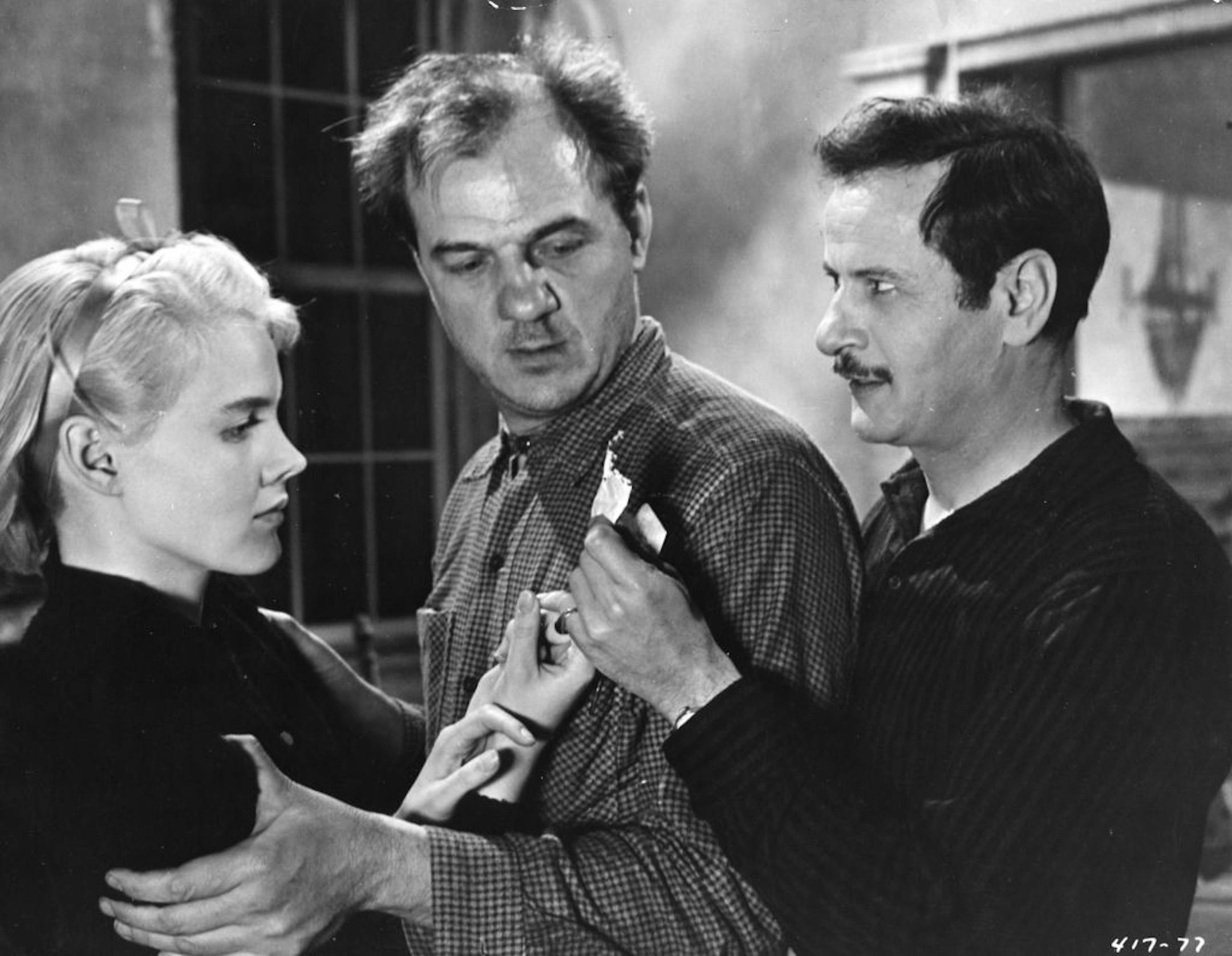 Carroll Baker, Karl Malden and Eli Wallach examine a bit of telling evidence in this scene from Warner Bros.' "Baby Doll," produced by Elia Kazan. Tennessee Williams wrote the film's script.
