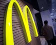 FILE - In this Dec. 17, 2014, file photo, a man walks by a McDonald's restaurant in Tokyo. McDonald&#xed;s Corp. on Thursday, July 23, 2015, reported 