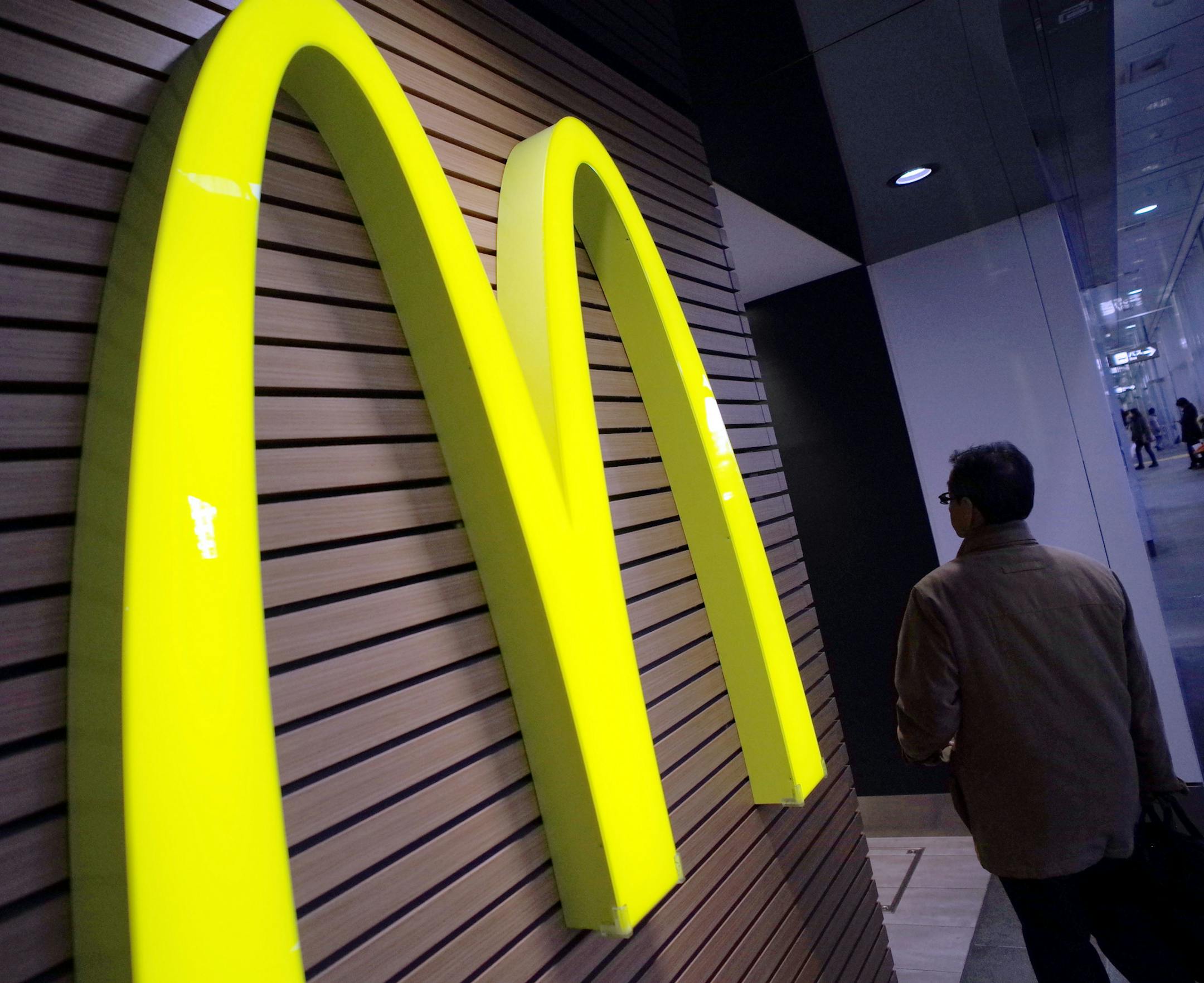 FILE - In this Dec. 17, 2014, file photo, a man walks by a McDonald's restaurant in Tokyo. McDonald&#xed;s Corp. on Thursday, July 23, 2015, reported a second-quarter profit of $1.2 billion. The results surpassed Wall Street expectations. (AP Photo/Eugene Hoshiko, File)
