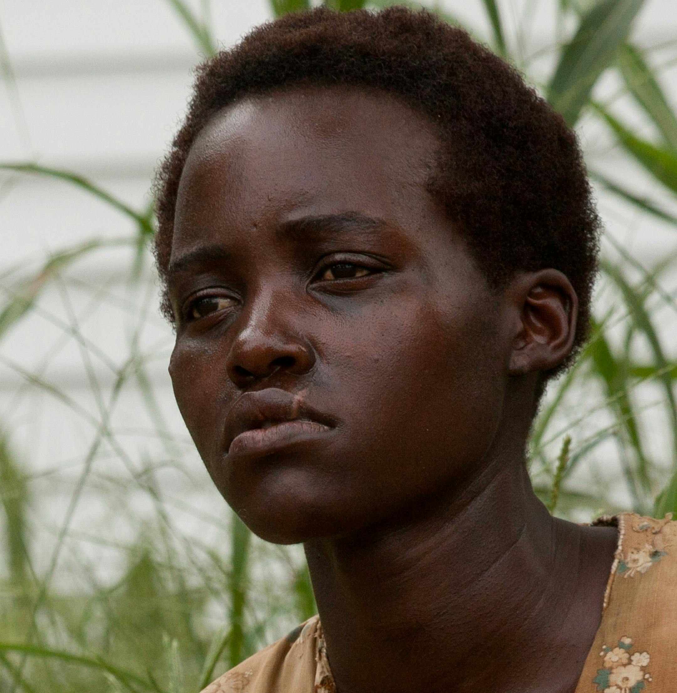 This image released by Fox Searchlight shows Lupita Nyongío in a scene from "12 Years A Slave." Nyong'o was nominated for a Golden Globe for best supporting actress in a motion picture for her role in the film on Thursday, Dec. 12, 2013. The 71st annual Golden Globes will air on Sunday, Jan. 12. (AP Photo/Fox Searchlight, Francois Duhamel)