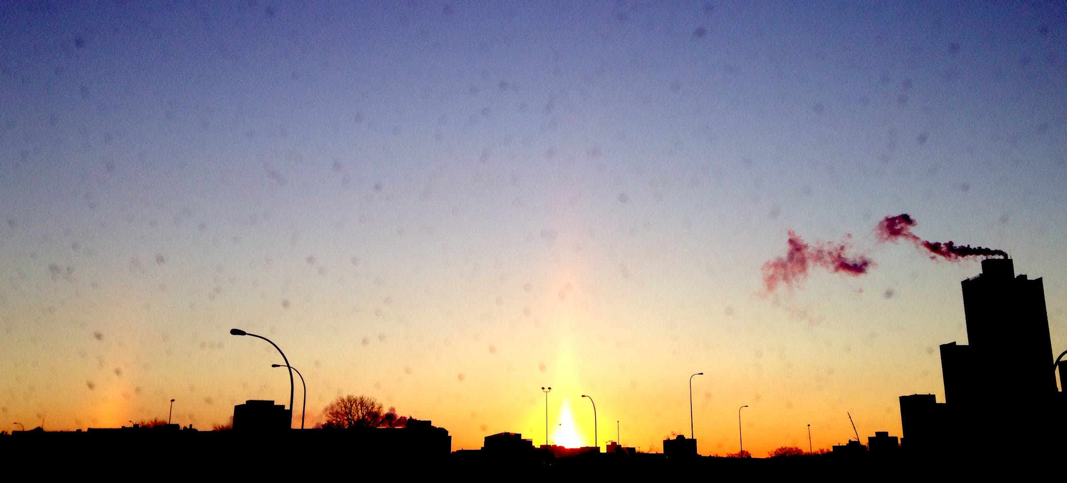 A sun pillar, formed by light refracting through ice crystals, lit up the early morning sky in Minneapolis near Washington Av. and 35W Friday, Dec. 6, 2013. The image was taken through a car windshield.