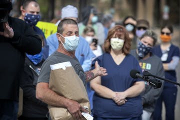 Cliff Willmeng, seen at a protest over hospital worker safety on May 4, is suing United Hospital over his May 8 firing.