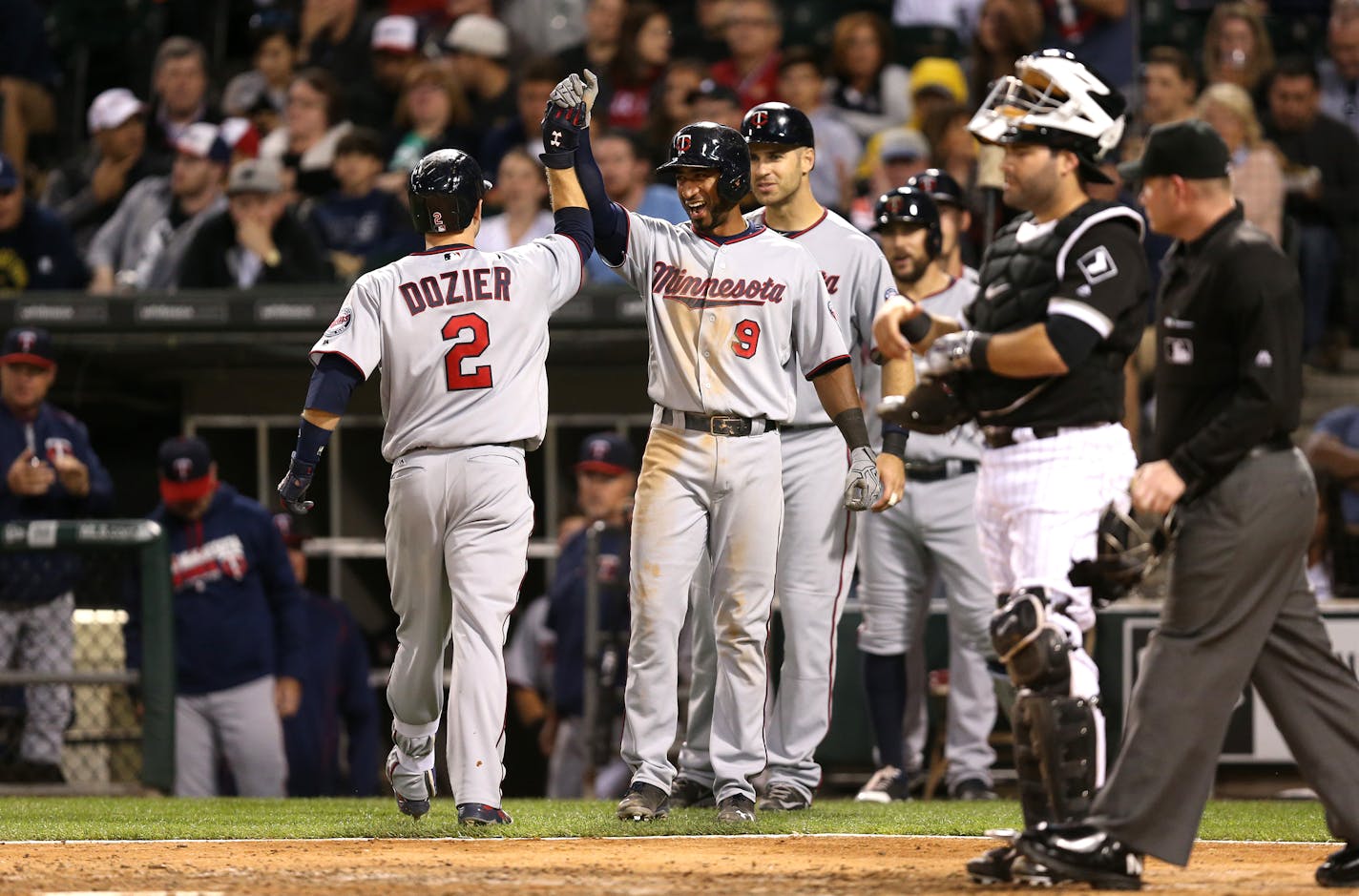 Minnesota Twins second baseman Brian Dozier (2) is congratulated by teammate Eduardo Nunez (9) after Dozier hit a three-run homer during the sixth inning on Tuesday, June 28, 2016, at U.S. Cellular Field in Chicago.