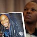 Alyce Hamilton held a picture of her son, Jelani Brinson, as she talked Wednesday about the reward being offered for any information about his death. 
