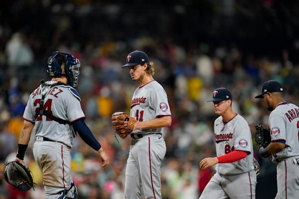 Twins starting pitcher Joe Ryan, center, looks on before exiting during the fifth inning Friday in San Diego.