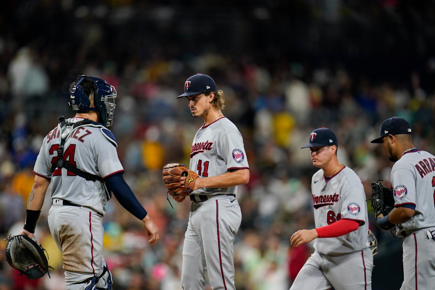 Twins starting pitcher Joe Ryan, center, looks on before exiting during the fifth inning Friday in San Diego.