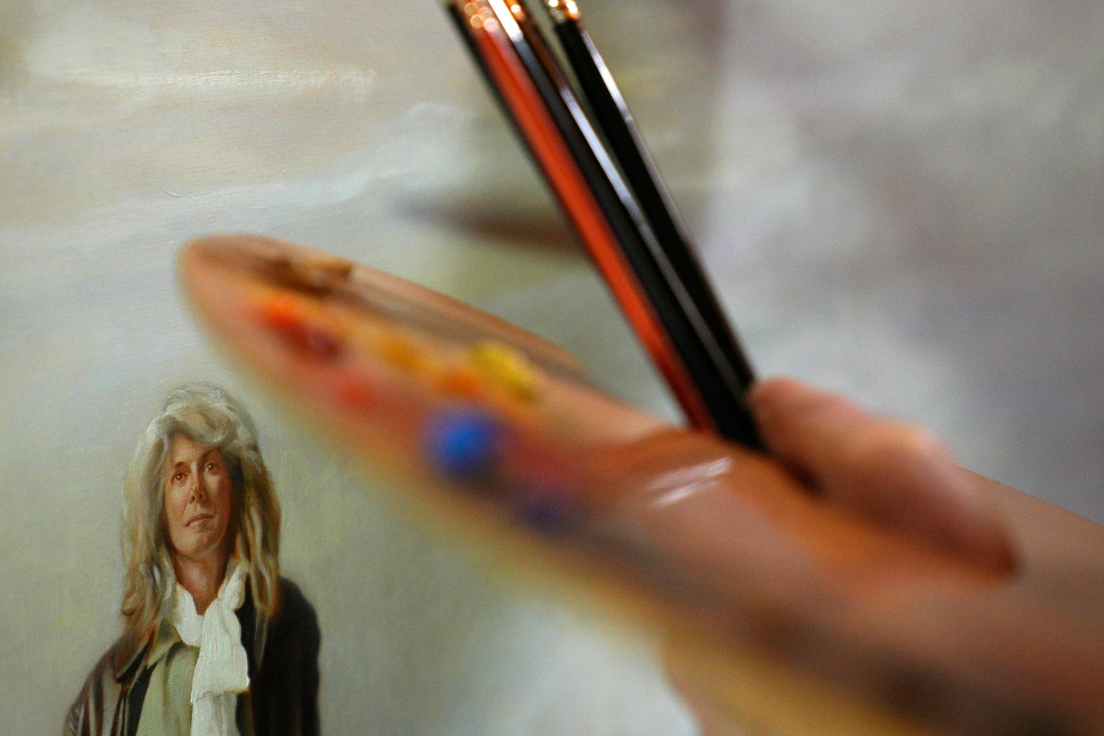Artist Charles Gilbert Kapsner's wife posed as a model for a figure in the last of five murals for his 10-year U.S. war veterans project at his studio in Little Falls.