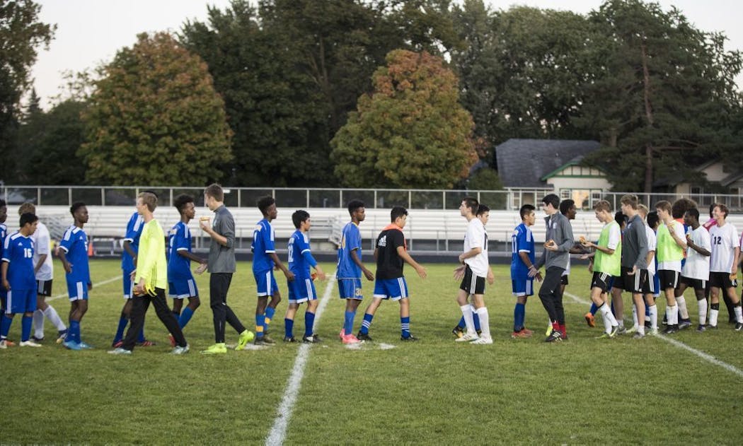 The Edison boys’ soccer team, shown shaking hands and walking to the right after a game in September, had to turn away players for budgetary reasons.