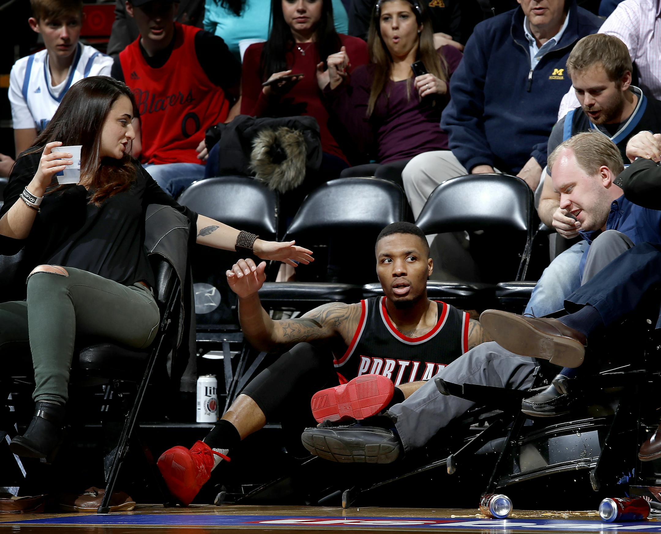 Damian Lillard (0) fell into the courtside seats while chasing a ball in the fourth quarter. ] CARLOS GONZALEZ ï cgonzalez@startribune.com - April 3, 2017, Minneapolis, MN, Target Center, NBA Basketball, Minnesota Timberwolves vs. Portland Trailblazers
