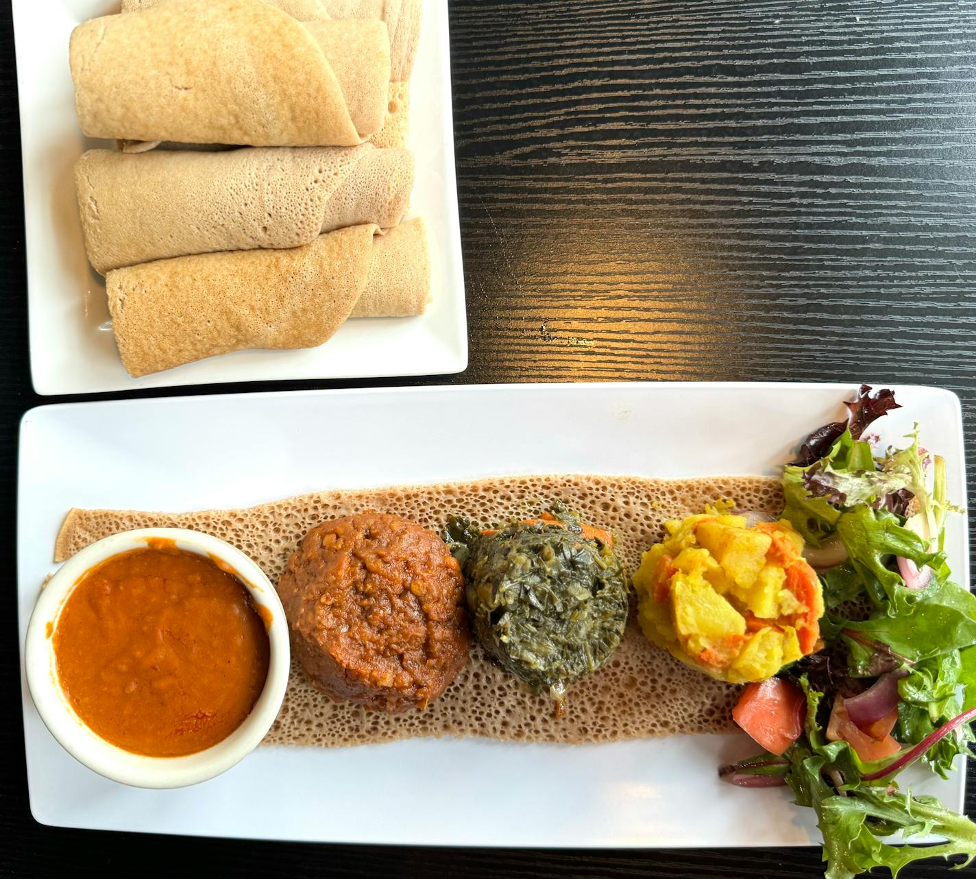 A vegan sampler stew platter of chickpeas, red lentils, greens and potatoes with carrots at Bole Ethiopian Cuisine, which has locations in Minneapolis and St. Paul.