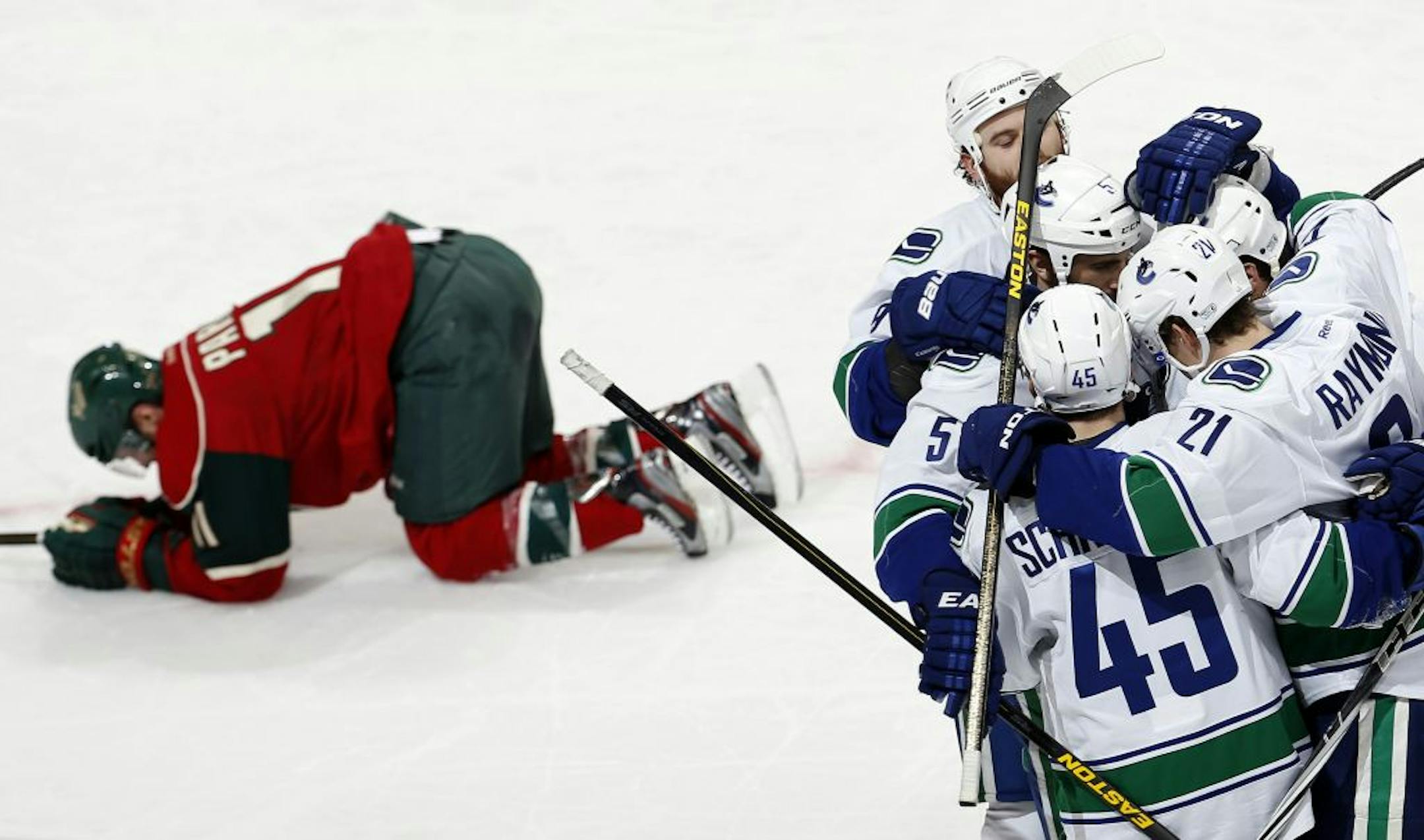 Zach Parise got up from the ice as the Canucks celebrated a goal by Mason Raymond in the second period.