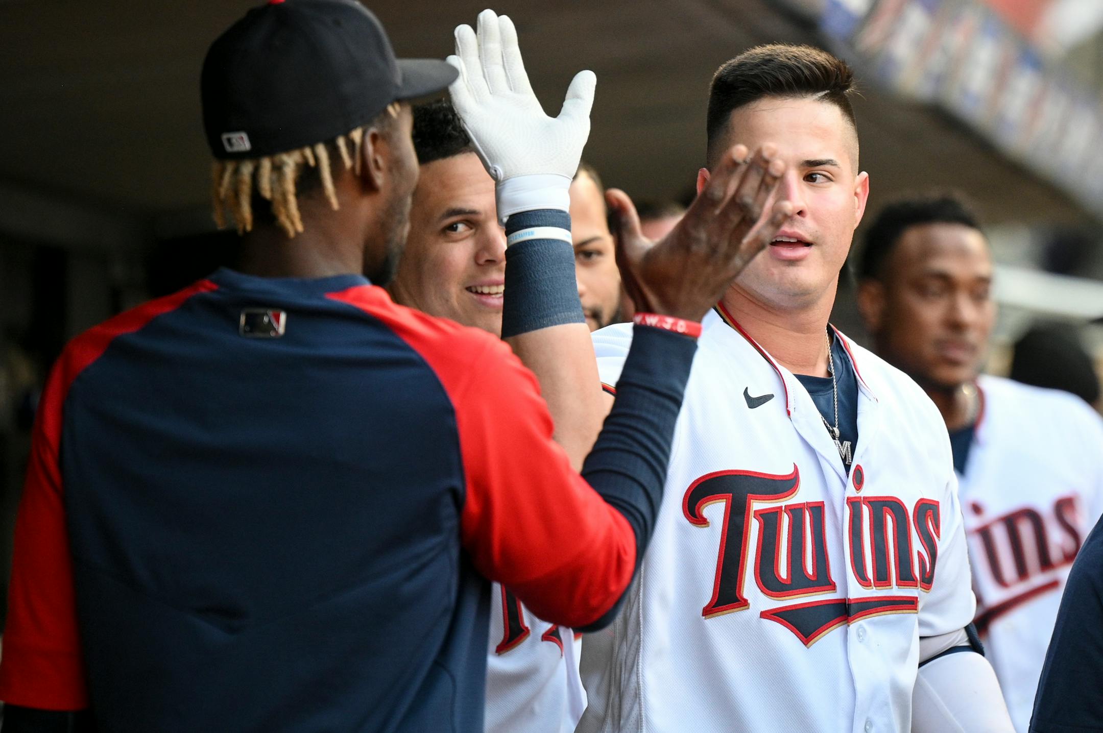 Minnesota Twins first baseman Jose Miranda (64) high fives shortstop Nick Gordon (1) in the dugout after Miranda's solo home run in the bottom of the second inning.