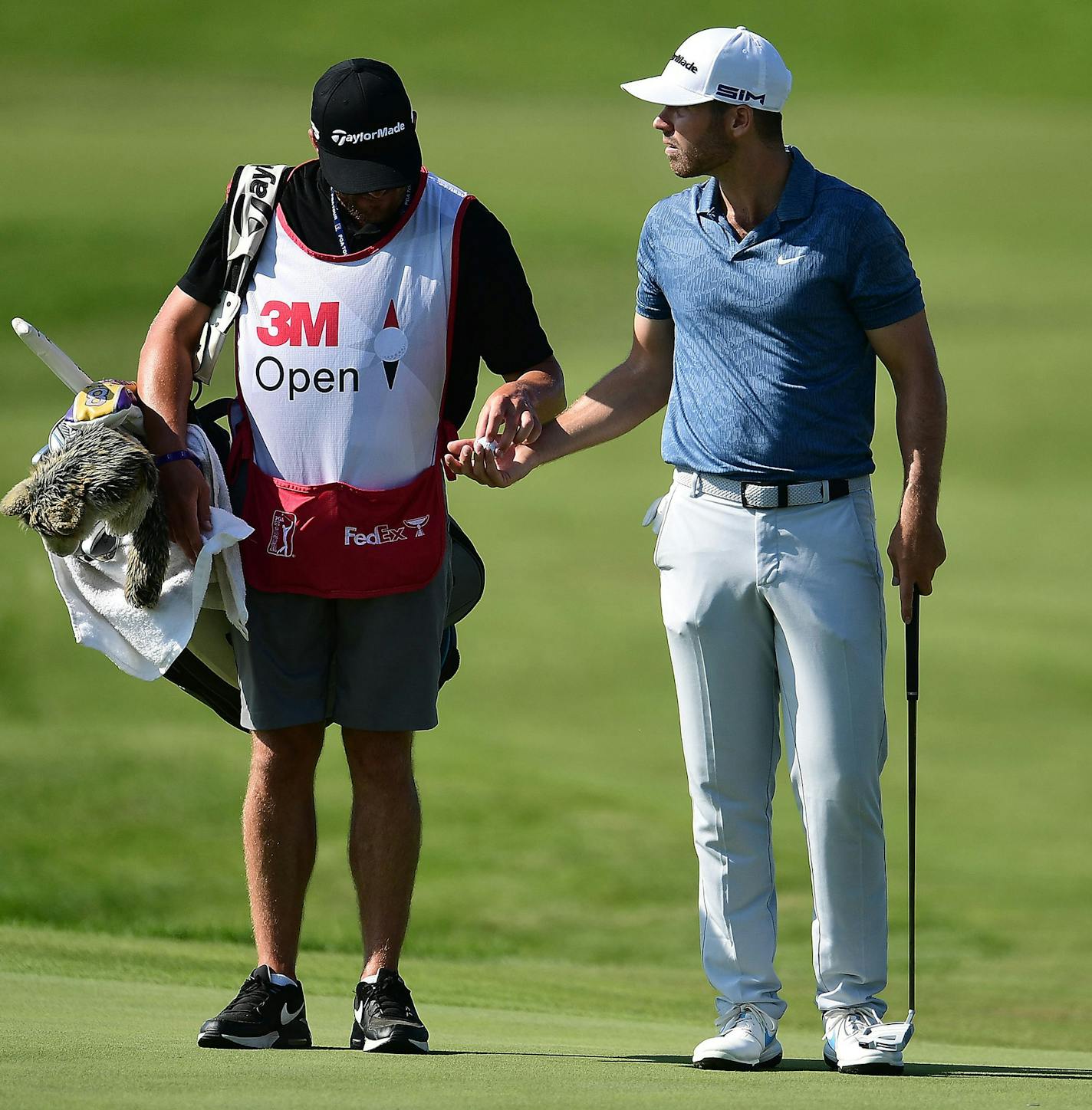 Matthew Wolff, right, talks with his caddie during the second round of the 3M Open on Friday, July 24, 2020, at TPC Twin Cities in Blaine, Minnesota. (Stacy Revere/Getty Images/TNS)