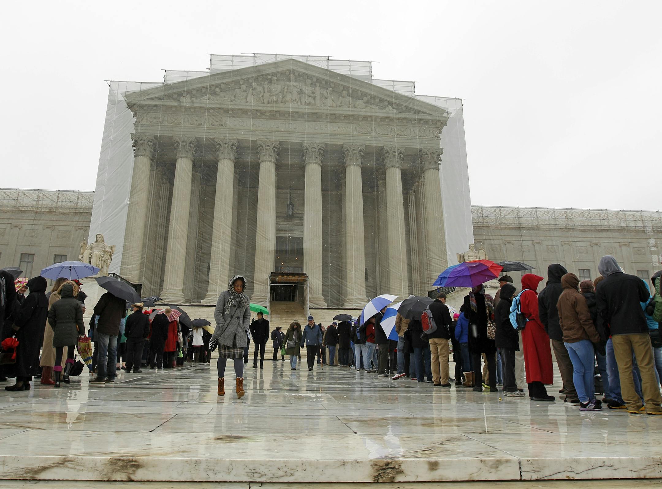 People wait to enter, outside of the U.S. Supreme Court, in Washington, on Monday March, 25, 2013, a day before the case for gay and lesbian couples rights, will be argued before the Supreme Court. (AP Photo/Jose Luis Magana)