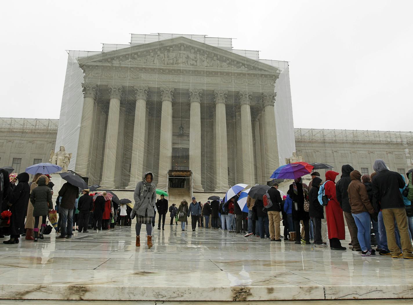 People wait to enter, outside of the U.S. Supreme Court, in Washington, on Monday March, 25, 2013, a day before the case for gay and lesbian couples rights, will be argued before the Supreme Court. (AP Photo/Jose Luis Magana)