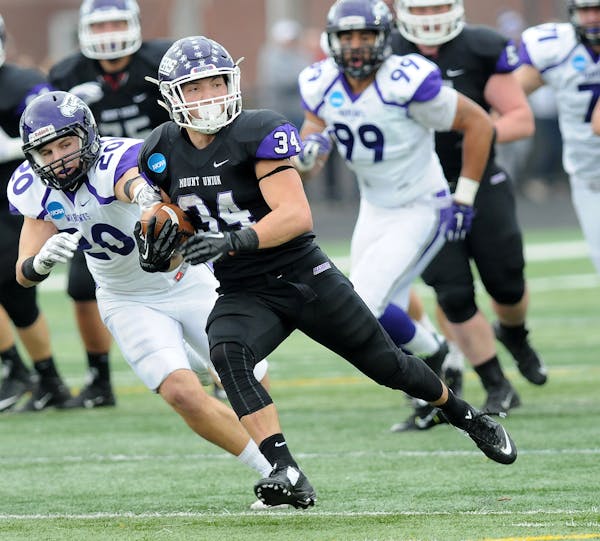 Mount Union Logan Nemeth (34) carries on a long run from scrimmage as Wisconsin-Whitewater's Shawn Shilcox pursues in the third quarter of the semifin