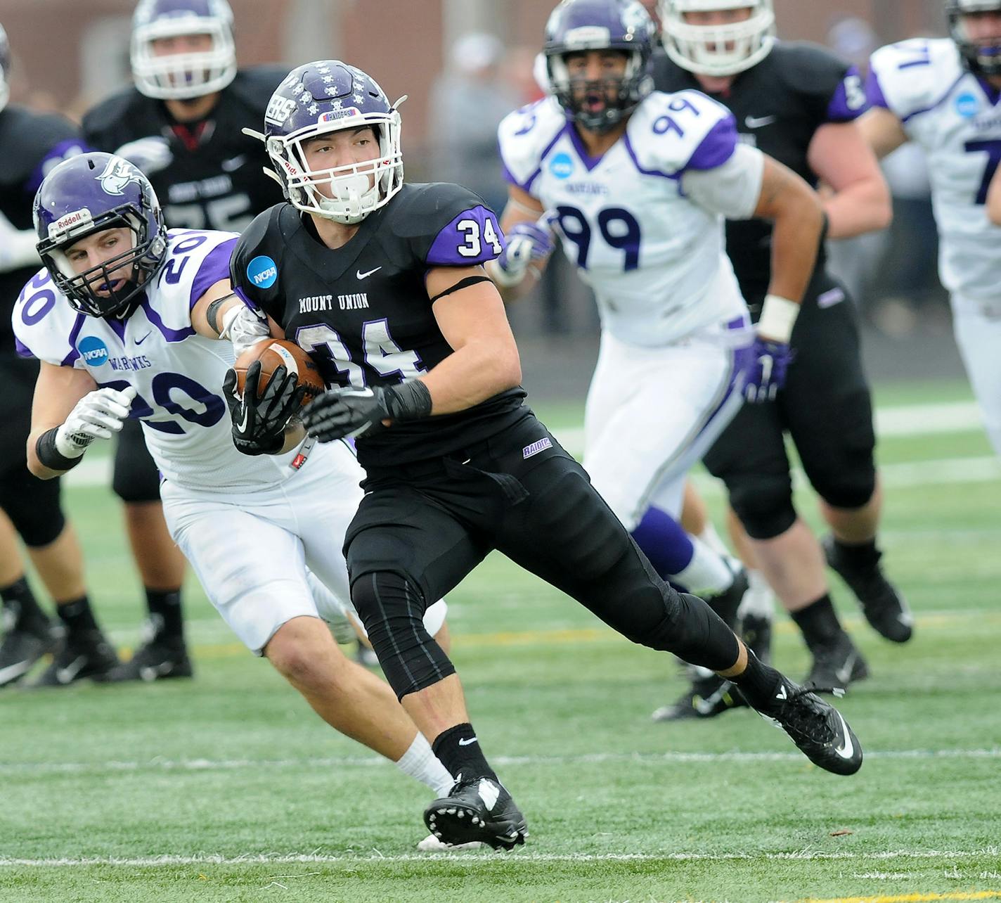 Mount Union Logan Nemeth (34) carries on a long run from scrimmage as Wisconsin-Whitewater's Shawn Shilcox pursues in the third quarter of the semifinals of an NCAA Division III college football game, Saturday, Dec. 12, 2015, in Alliance, Ohio. (Ed Hall Jr./The Review via AP) MANDATORY CREDIT