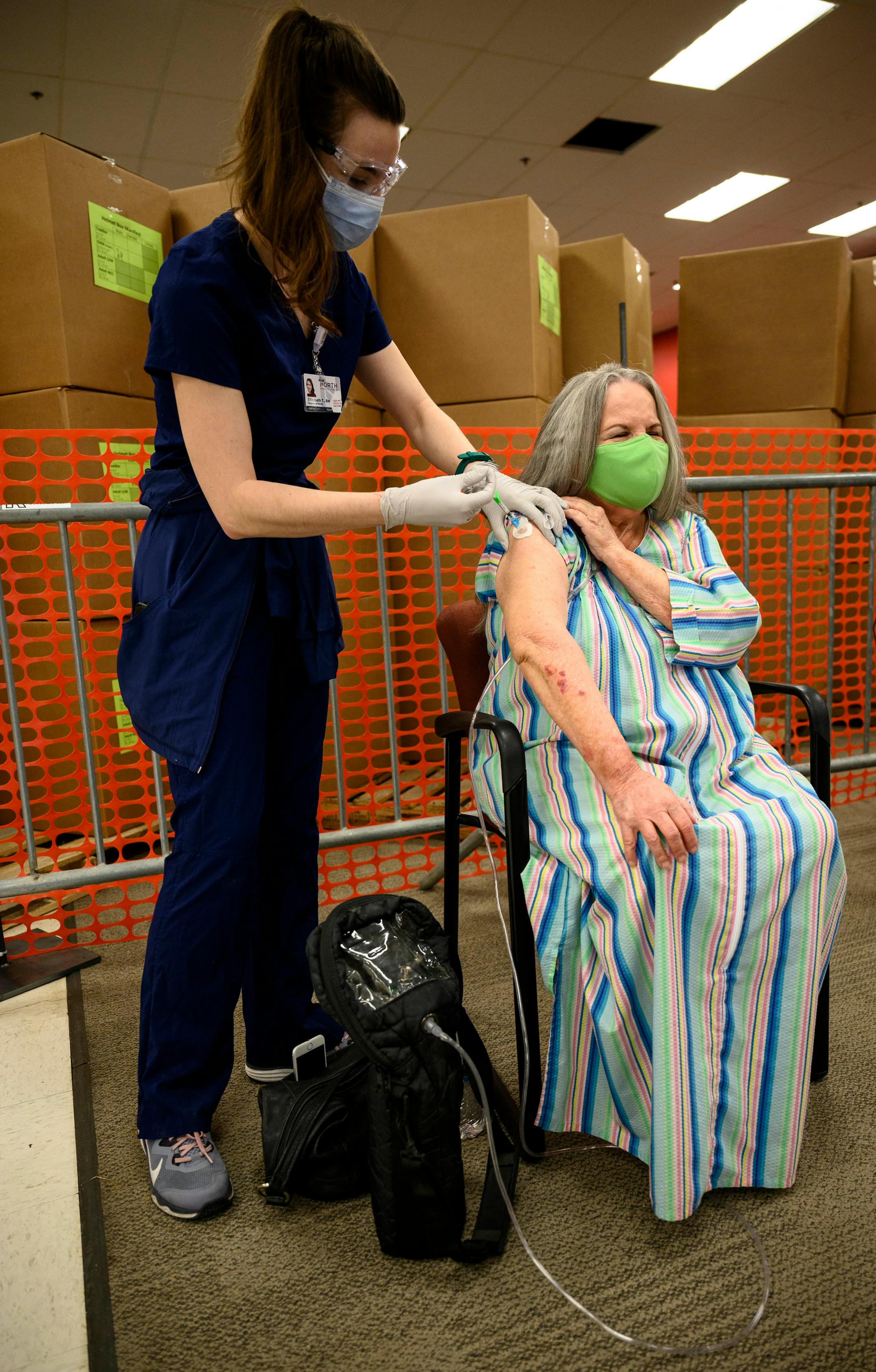 Elizabeth Turner, a contract nurse working at the North Memorial Health Hospital vaccination clinic in Brooklyn Center, administered a dose of the Moderna COVID-19 vaccine to Darlene Spencer, 72, of Corcoran. Spencer suffers from a host of respiratory issues, including COPD, and says today was the first time she's left her home in a year. She says she's most looking forward to shopping.