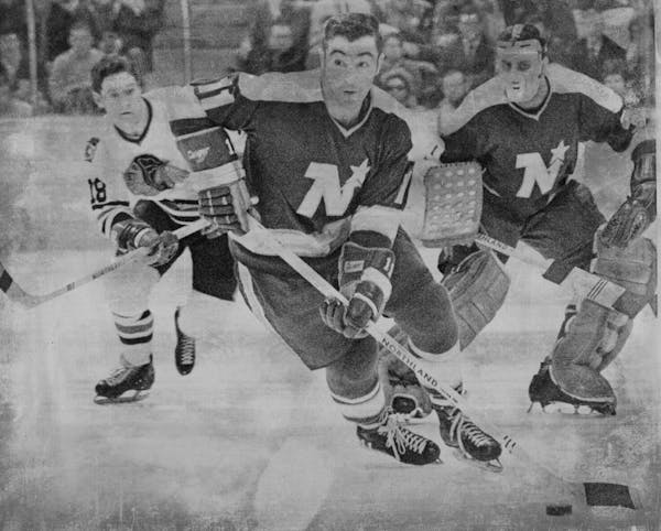 Parise is action against Chicago in 1970. The Blackhawks player is Gerry Pinder.