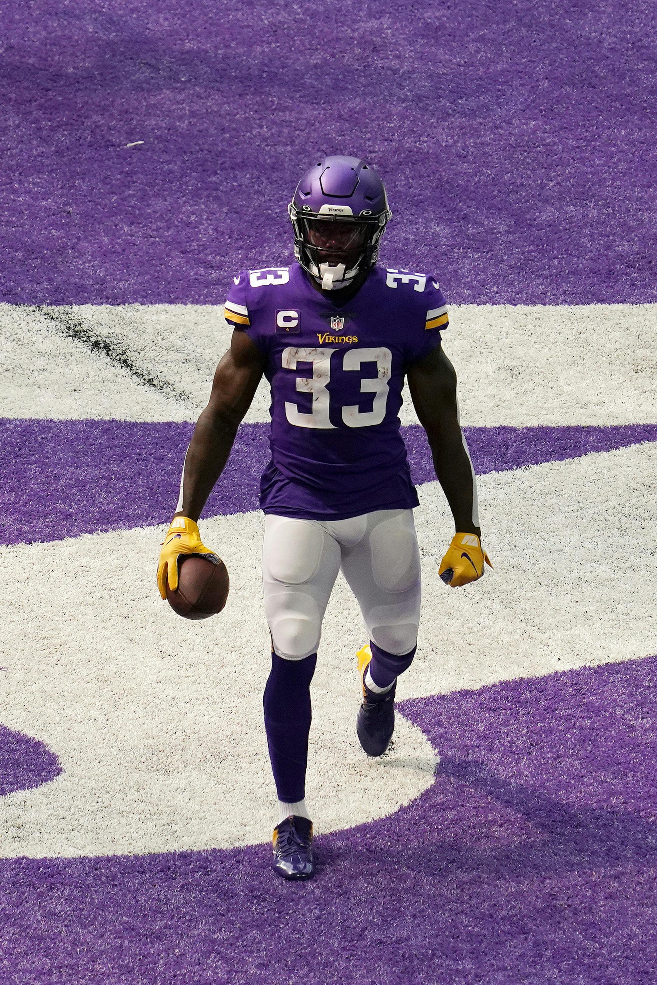 Minnesota Vikings running back Dalvin Cook (33) celebrated after he ran the ball into the end zone past the tackle by Green Bay Packers outside linebacker Christian Kirksey (58) for a touchdown in the first quarter.
