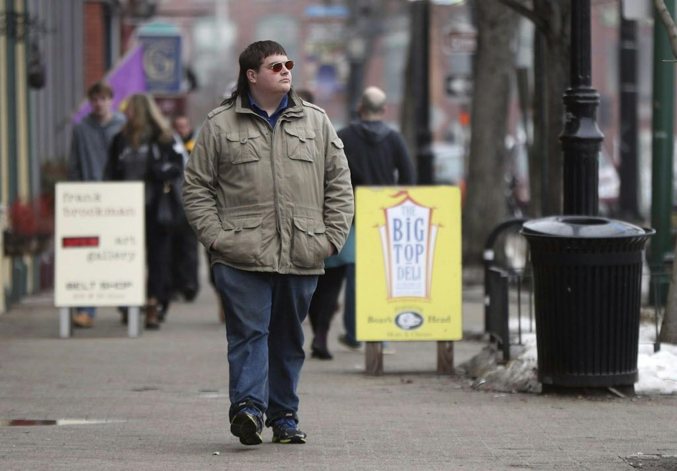 In this Feb. 24, 2017 photo, Chaz Wing walks down Maine Street in Brunswick, Maine. Wing has testified that he was raped by other kids three times in his first year in junior high, even after repeatedly complaining of harassment to teachers and administrators. Chaz�s saga is more than a tale of escalating bullying. Across the U.S., thousands of students have been sexually assaulted, by other students, in high schools, junior highs and even elementary schools _ a hidden horror educators have long