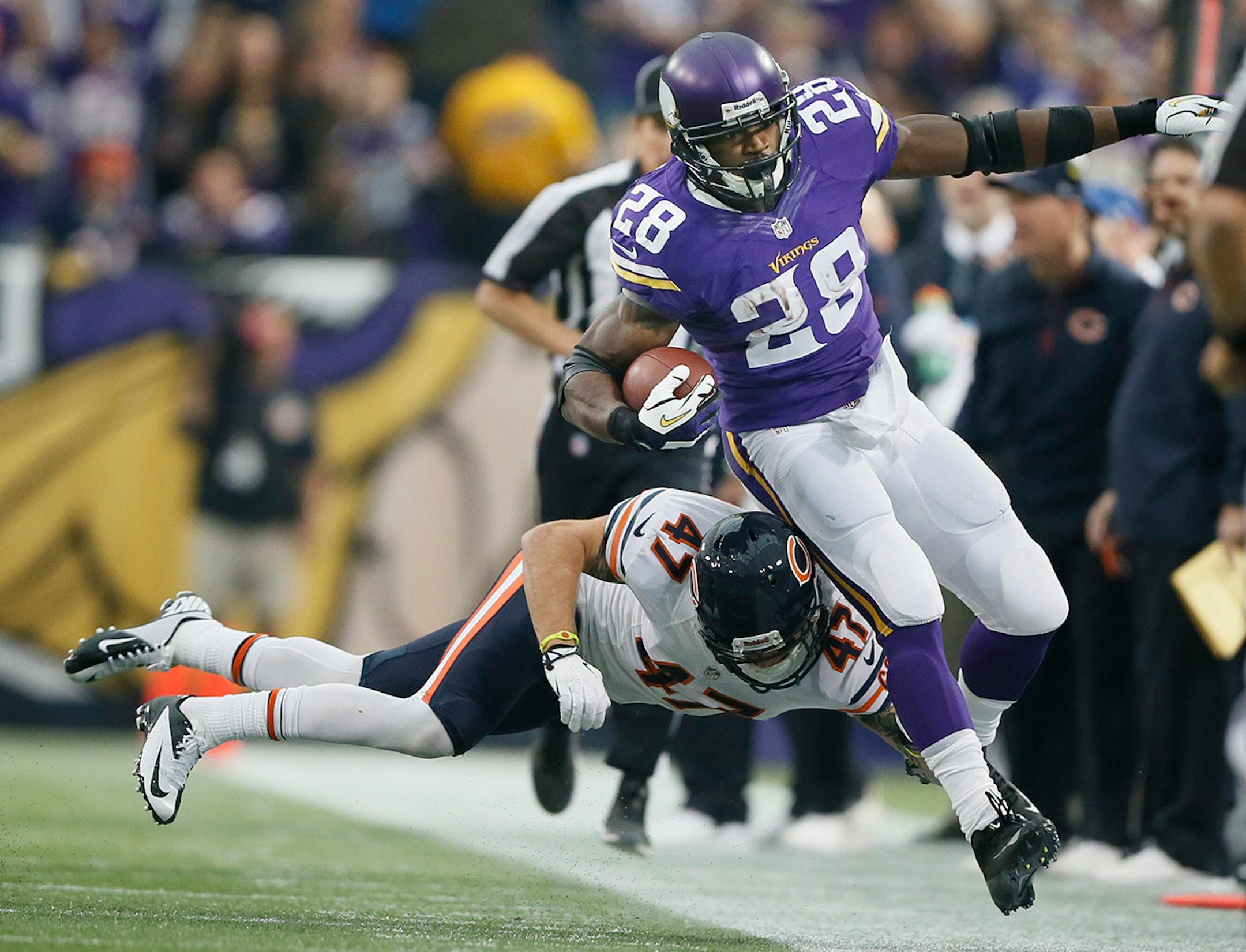 Adrian Peterson (28) was knocked out of bounds by Chicago Bears free safety Chris Conte (47) after picking up a first down in the first quarter against the Chicago Bears at Mall of America Field Sunday December 01, 2013.