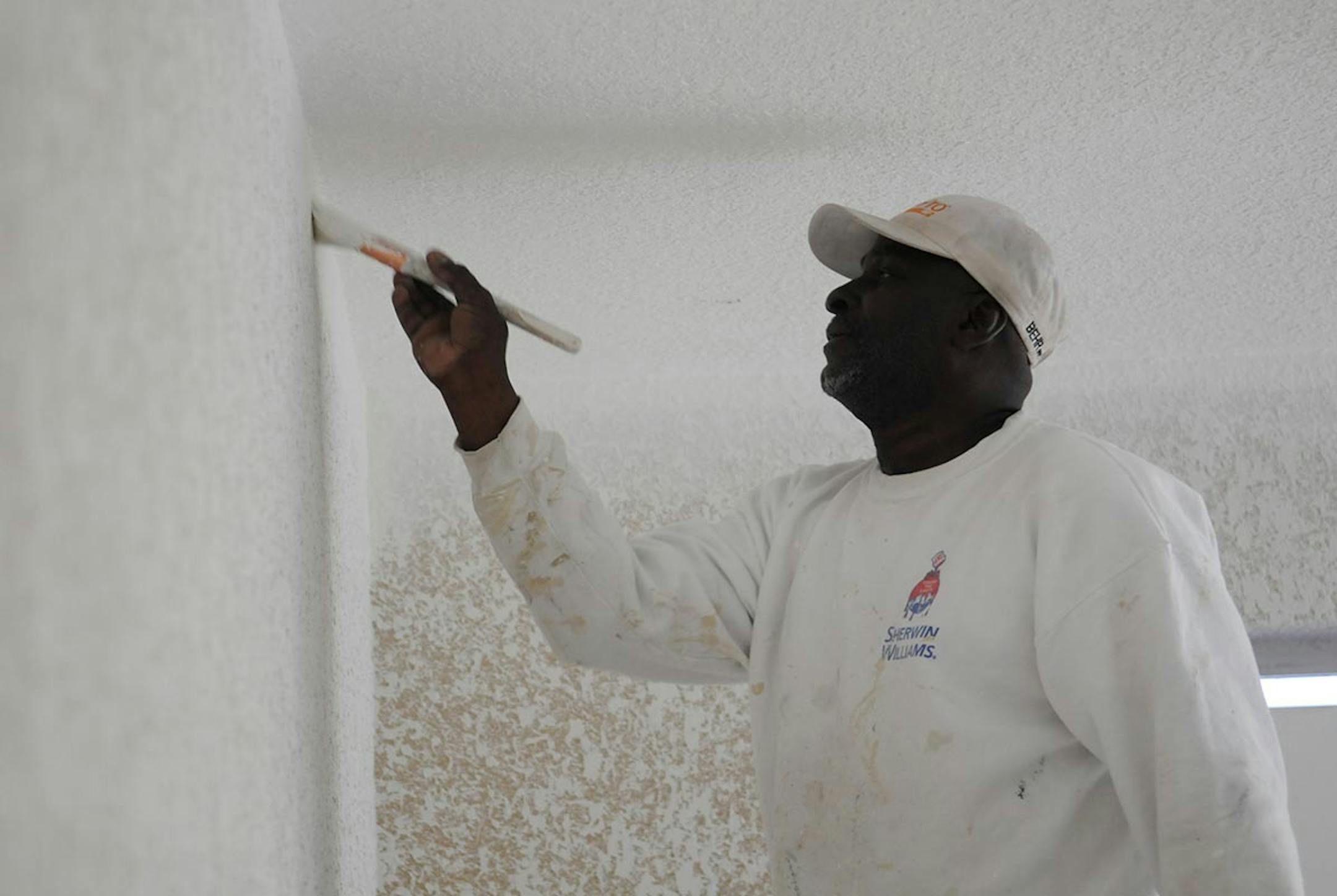 Sonman Painting and Waterproofing, Inc. owner Sonman McFadden paints the inside of a Fort Lauderdale, Florida, home young investor Mike Benton intends to fix up and re-sell, on February 28, 2013. (Taimy Alvarez/Sun Sentinel/MCT) ORG XMIT: 1135730