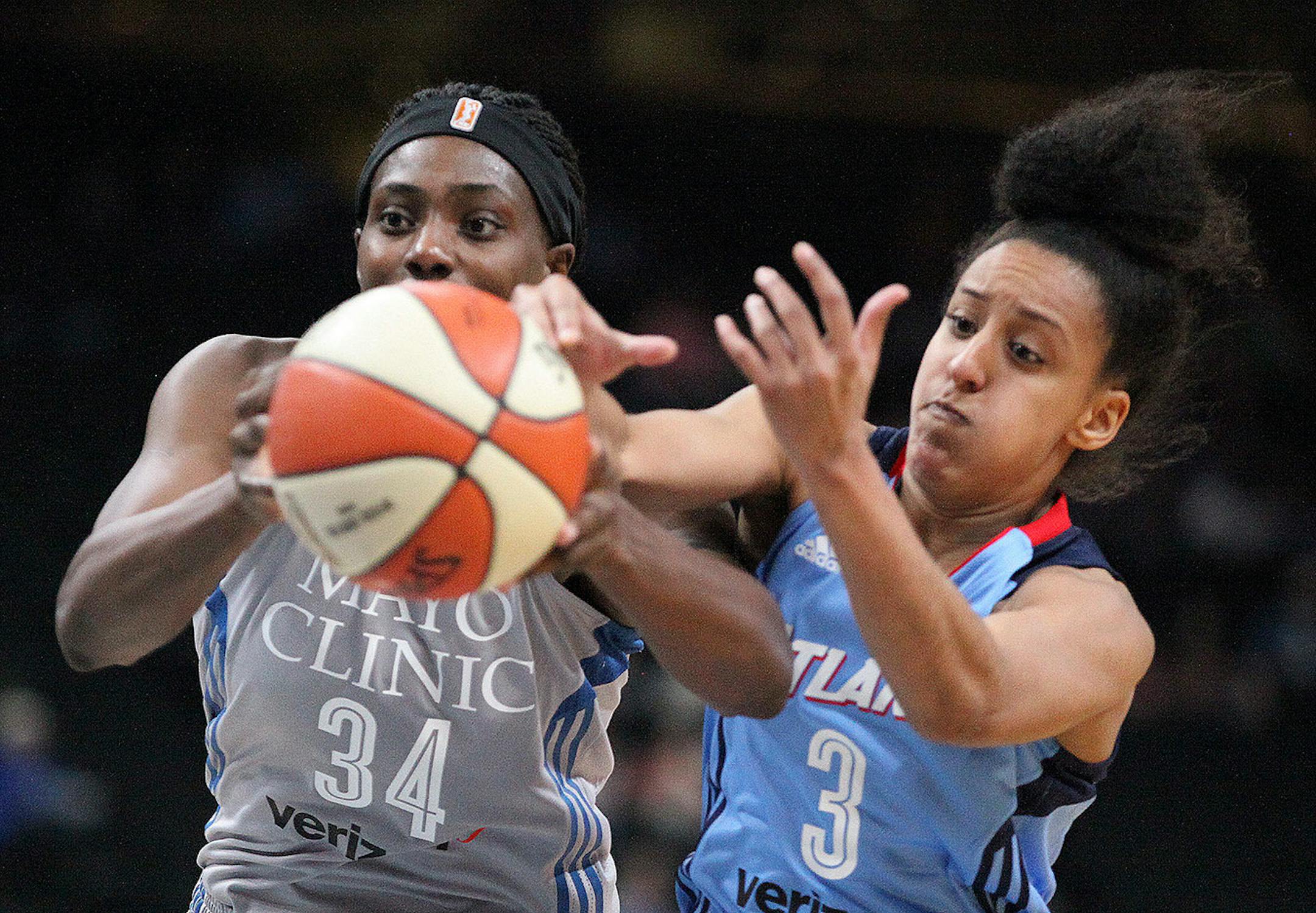 Minnesota Lynx center Sylvia Fowles (34) controls a rebound against the Altanta dream's Brianna Kiesel.