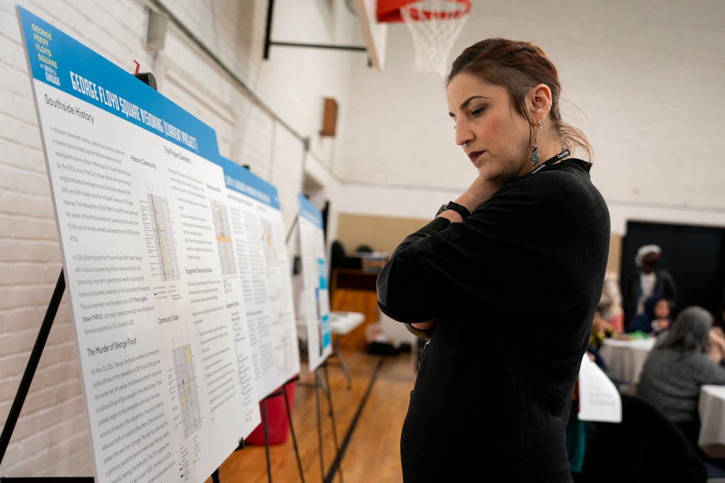 Addy Gonzalez looks at proposed plans set up at the community meeting to discuss the future of George Floyd Square at Sabathani Community Center on Thursday in Minneapolis.