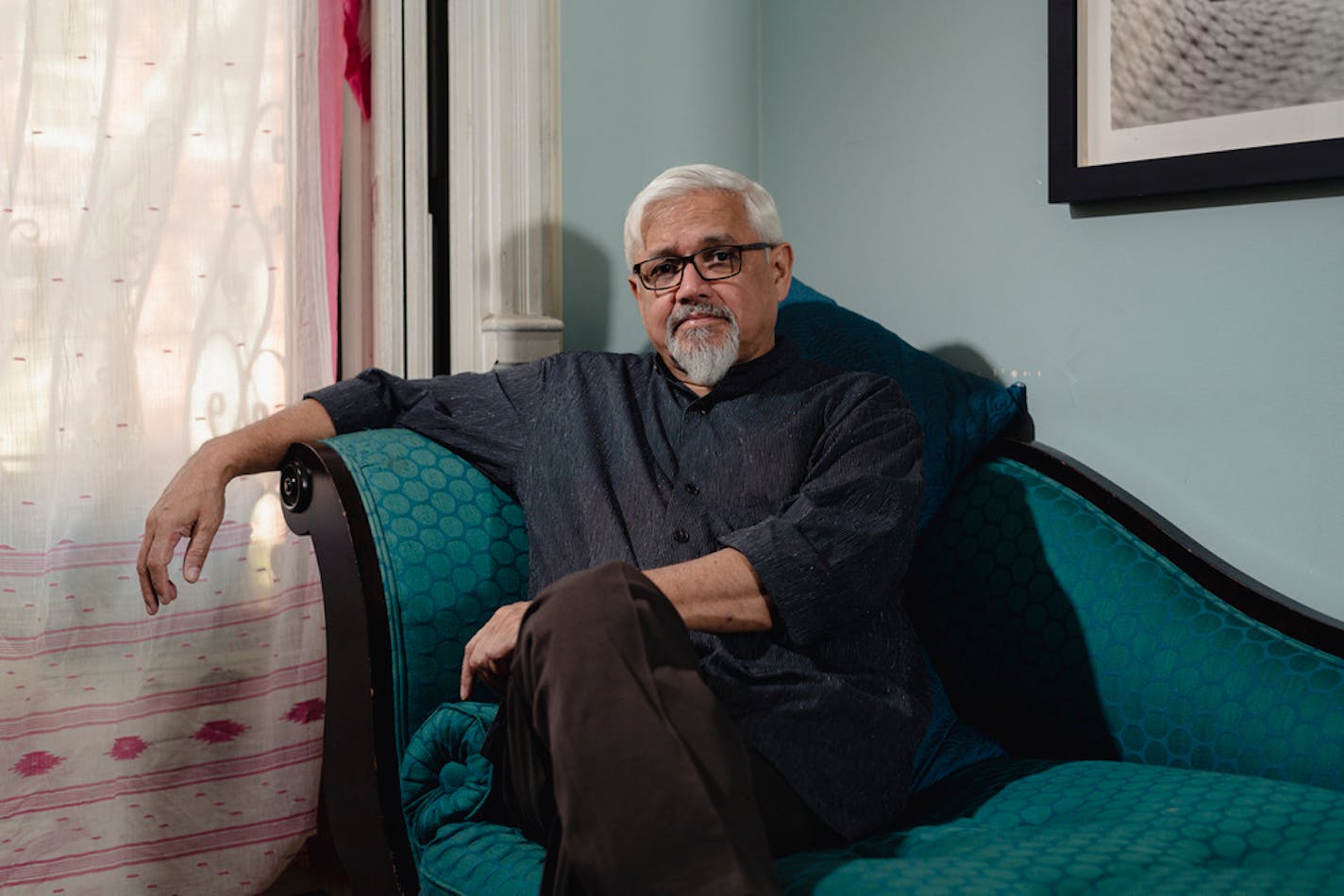 Author Amitav Ghosh at his home in Brooklyn, Aug. 22, 2019. His 12th book, "Gun Island," is about a rare book dealer drawn into a globe-spanning adventure with Bangladeshi migrants in Libya, dolphins in the Mediterranean and venomous water snakes in California.