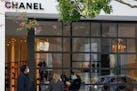 Customers wearing masks waited to enter a Chanel store Wednesday, in the West Hollywood area of Los Angeles. Los Angeles County imposed new restrictio