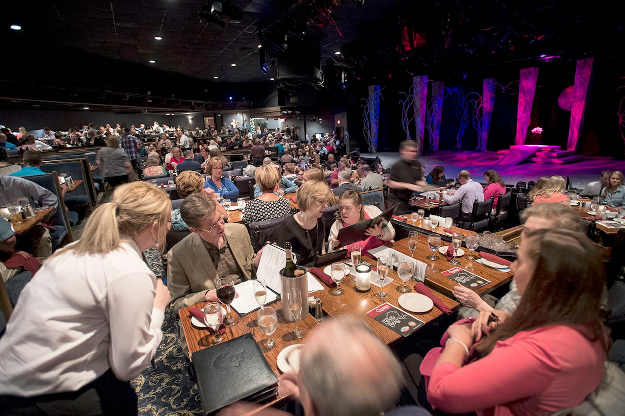 Server Jordan Brown, of Chaska, bottom left, took orders during a Friday night at Chanhassen Dinner Theatres before the start of "Beauty and the Beast."