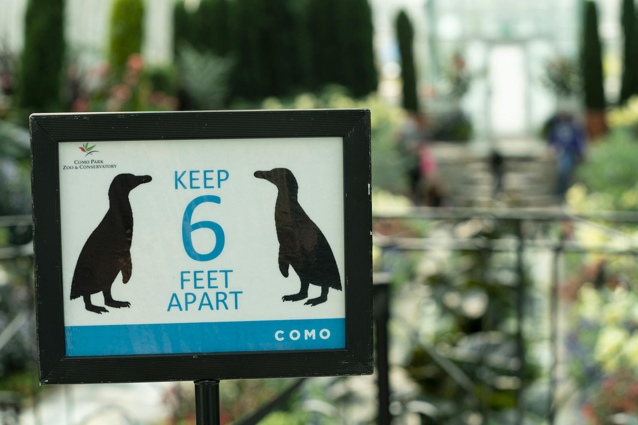 Signs reminded visitors to socially distance in the Sunken Garden, a popular site for selfies.