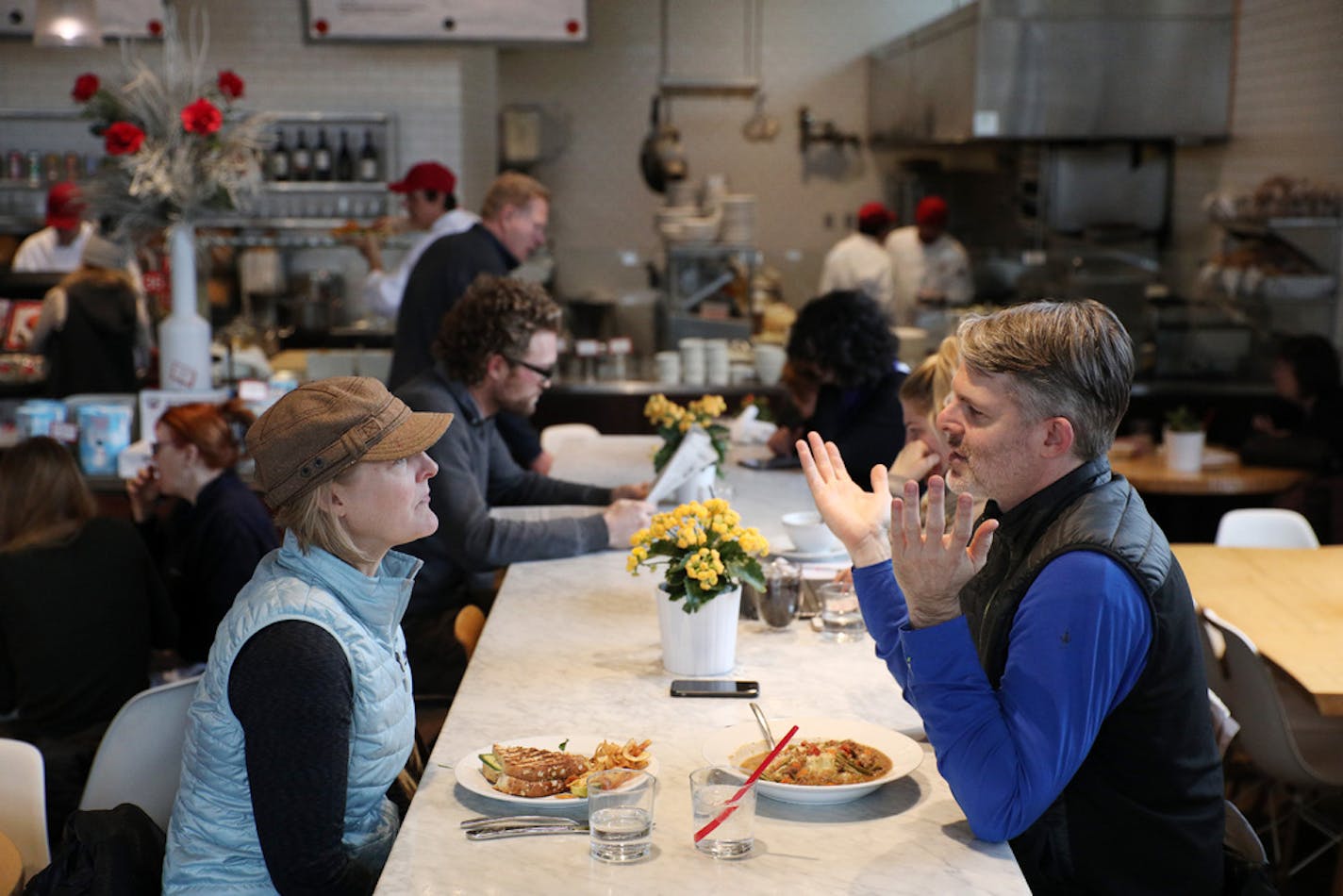 Dinners, including Kate Jackson, left, and Michael Pilhofer, sat together at a communal table Tuesday at Yum! in St. Louis Park. ] ANTHONY SOUFFLE • anthony.souffle@startribune.com Dinners sat together at a communal table Tuesday, Jan. 30, 2018 at Yum! in St. Louis Park, Minn. The sharing-with-strangers phenomenon is realtivily new to arms-length Minnesota.