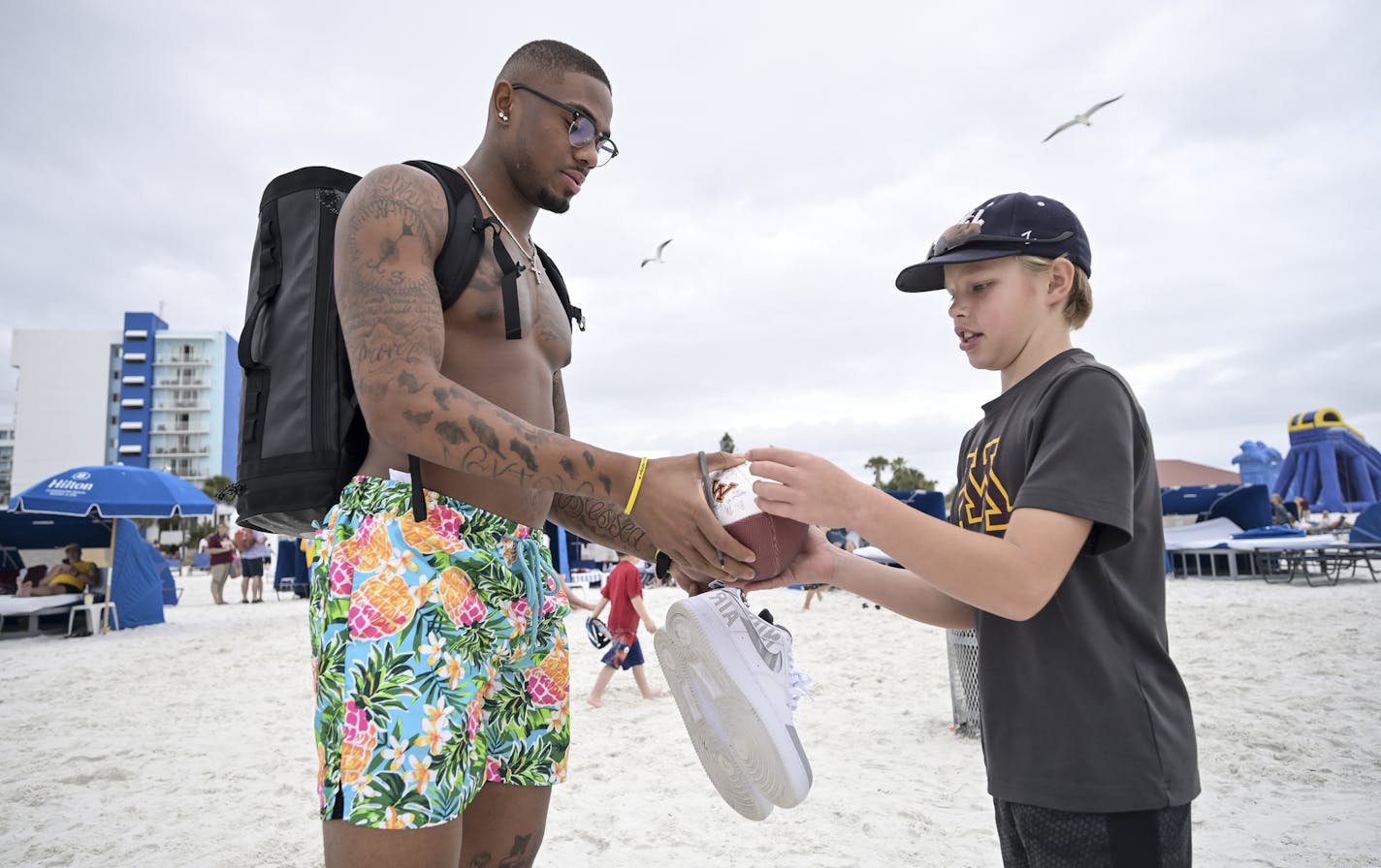 Minnesota Gophers wide receiver Rashod Bateman (13) signed a football for Isaac Harder, 11, of Rosemount, during the Outback Bowl's Beach Day Monday. ] Aaron Lavinsky &#x2022; aaron.lavinsky@startribune.com The Outback Bowl's Beach Day was held Monday, Dec. 30, 2019 at Clearwater Beach, Fla. The event featured exhibitions from the University of Minnesota and Auburn's marching bands, a tug-of-war competition between cheer squads and gave fans the opportunity to interact with student athletes at t