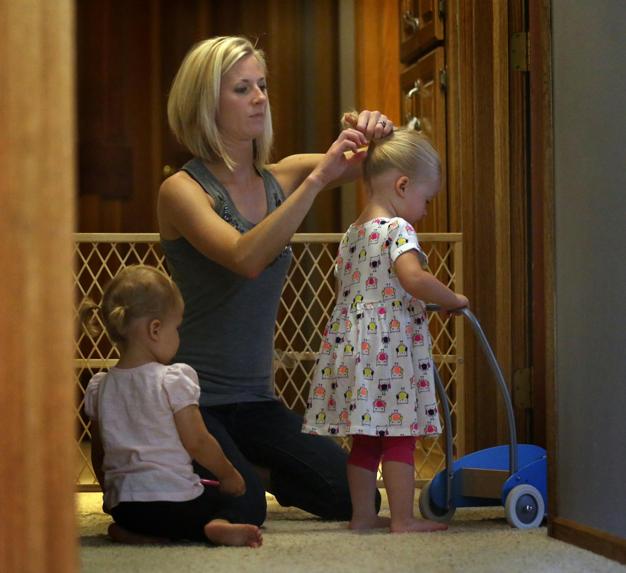 Sable Gass fashioned a ponytail in the hair of her daughter, Louella, 20 months, while Susan Stone�s child, Collin, almost 2, looked on.